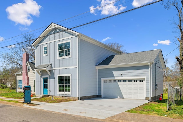 traditional home featuring board and batten siding, driveway, and a garage
