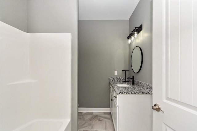 full bathroom with baseboards and vanity