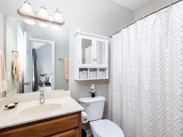 bathroom with toilet and vanity