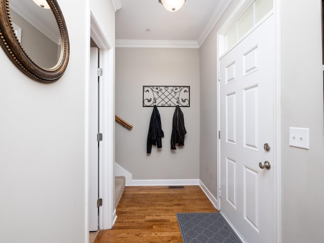 doorway with baseboards, stairway, light wood-type flooring, and crown molding