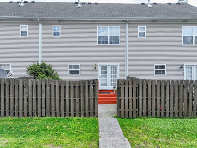 exterior space with fence and a shingled roof