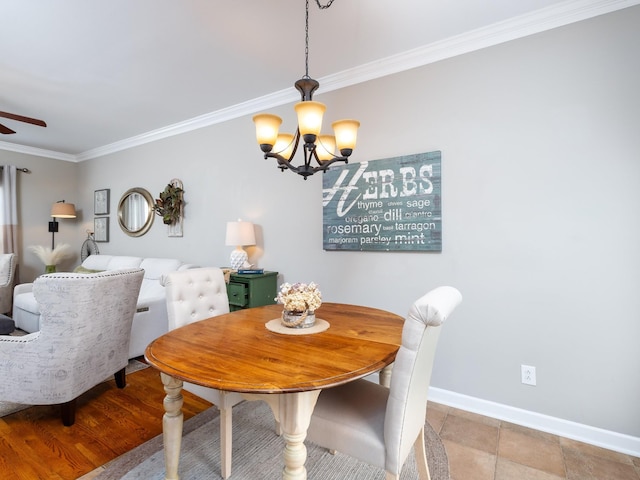 dining space featuring crown molding, ceiling fan with notable chandelier, and baseboards