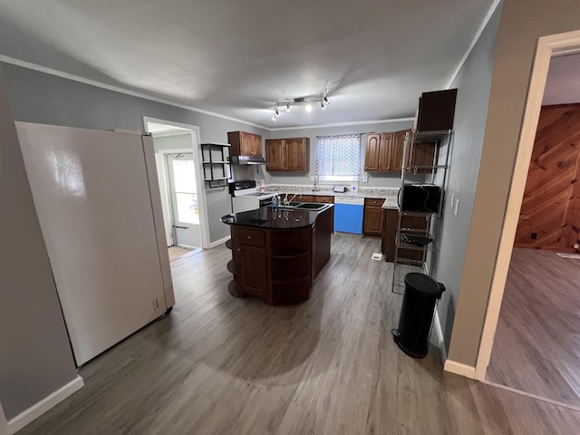 kitchen with a center island, baseboards, white appliances, wood finished floors, and open shelves
