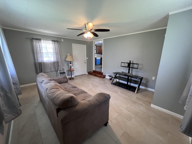 living room featuring a ceiling fan, baseboards, and ornamental molding