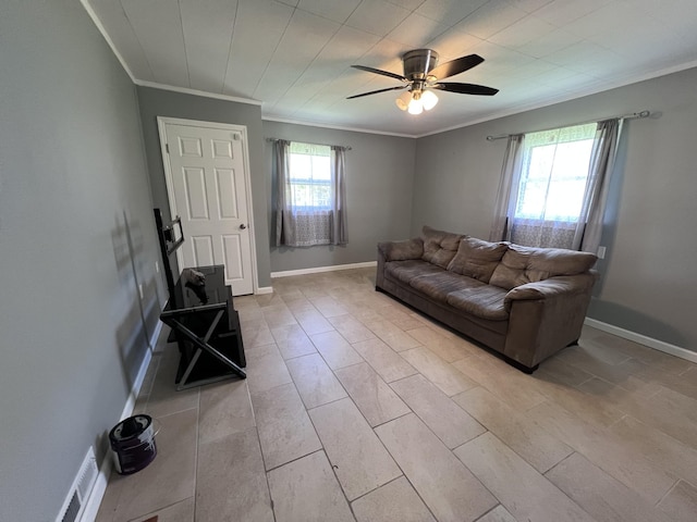 living room featuring visible vents, crown molding, baseboards, and a ceiling fan