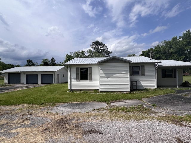 31 Marler St, Tracy City, TN 37387 - view of front of house with a garage, metal roof, a front lawn, and an outdoor structure