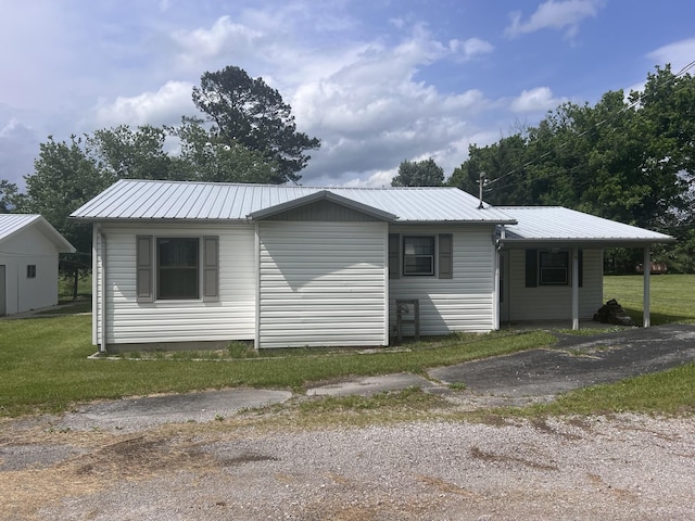 31 Marler St, Tracy City, TN 37387 - view of home's exterior featuring metal roof and a lawn
