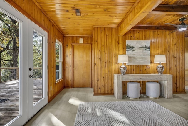 interior space with access to exterior, wood finished floors, wooden walls, and wood ceiling