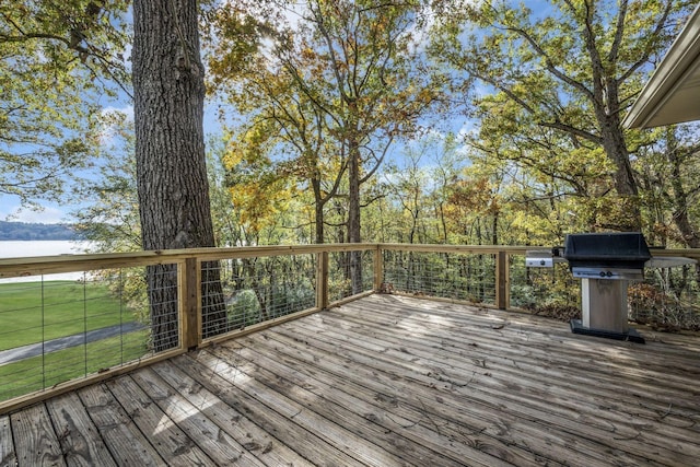 deck with a water view and area for grilling