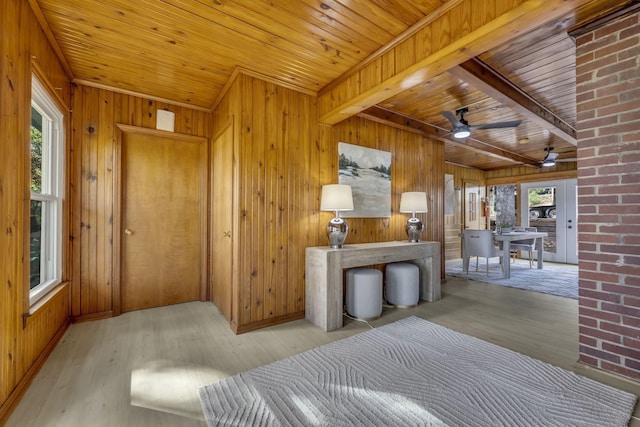 living area featuring plenty of natural light, wood finished floors, wood ceiling, and wood walls