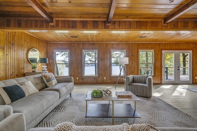 living area with a wealth of natural light, beamed ceiling, wood ceiling, and french doors