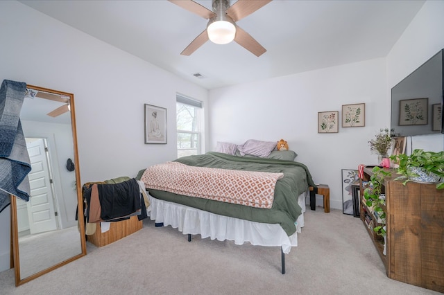carpeted bedroom with visible vents and ceiling fan