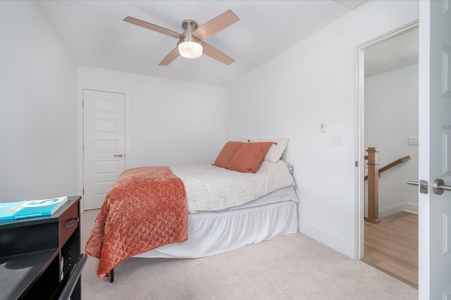 carpeted bedroom featuring baseboards and a ceiling fan