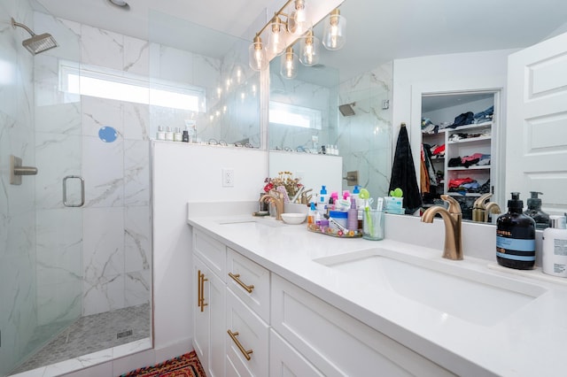 bathroom featuring a wealth of natural light, a sink, and a marble finish shower