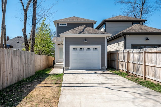 view of front of home with roof with shingles, an attached garage, fence, driveway, and entry steps