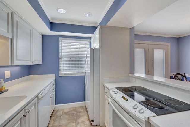 kitchen with crown molding, light countertops, a sink, white cabinetry, and white appliances
