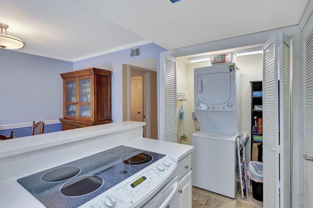 kitchen featuring light countertops, ornamental molding, stacked washing maching and dryer, electric range oven, and visible vents
