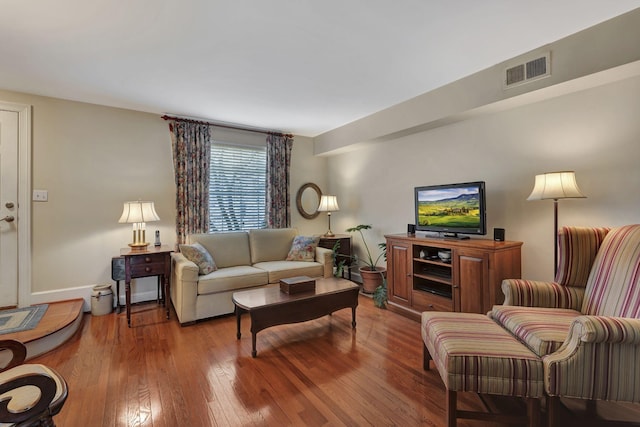 living room with wood-type flooring and visible vents