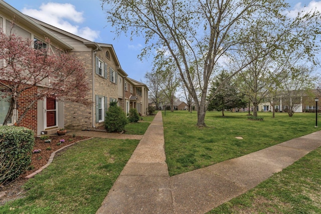 view of community featuring a residential view and a lawn