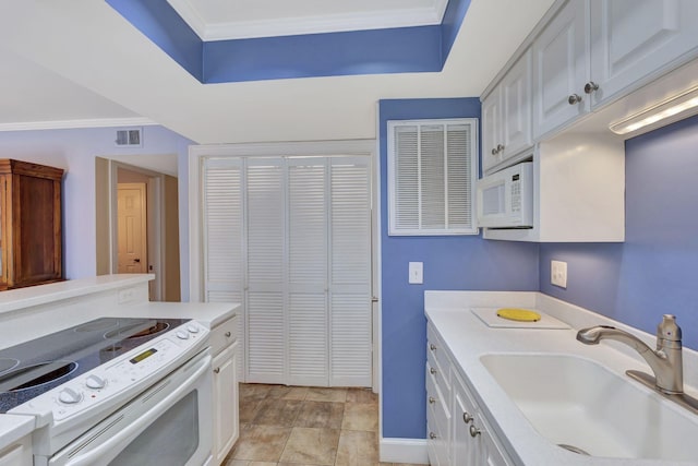kitchen with white appliances, light countertops, ornamental molding, and a sink
