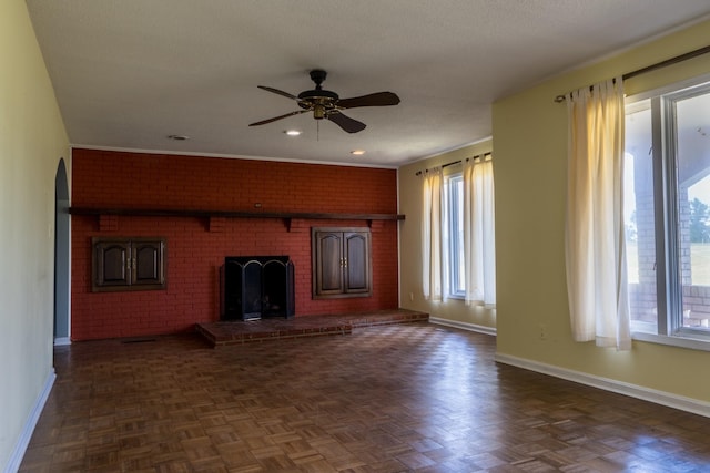 2589 Presley Ridge Rd, Sardis, TN 38371 - unfurnished living room with a fireplace, a textured ceiling, ceiling fan, and baseboards