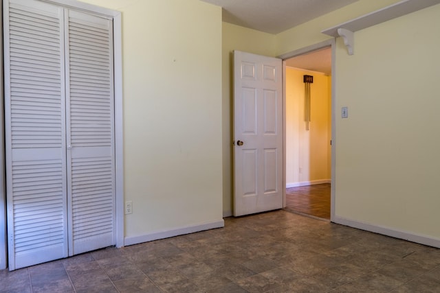 2589 Presley Ridge Rd, Sardis, TN 38371 - unfurnished bedroom with baseboards, a closet, and stone finish flooring