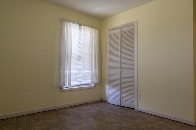 2589 Presley Ridge Rd, Sardis, TN 38371 - unfurnished bedroom featuring baseboards, a closet, and a textured ceiling