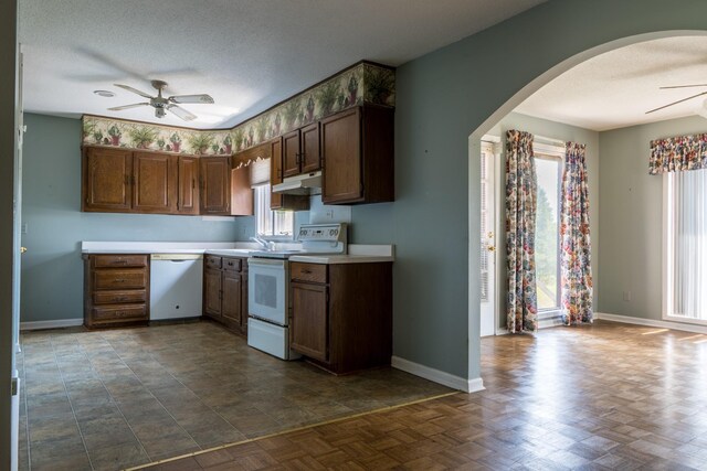 2589 Presley Ridge Rd, Sardis, TN 38371 - kitchen featuring a ceiling fan, under cabinet range hood, baseboards, white appliances, and arched walkways