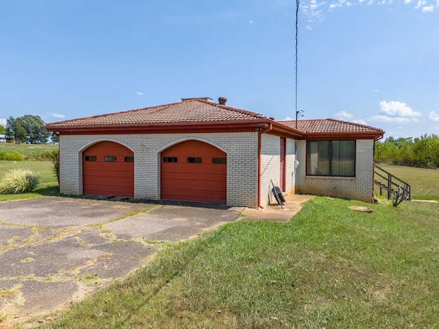 2589 Presley Ridge Rd, Sardis, TN 38371 - view of front of home featuring an attached garage, brick siding, a tiled roof, and a front yard