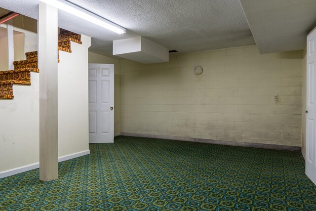 2589 Presley Ridge Rd, Sardis, TN 38371 - finished basement with a textured ceiling, concrete block wall, and baseboards