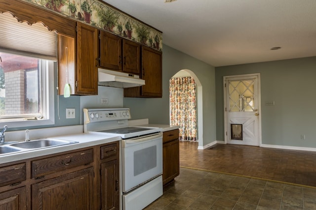 2589 Presley Ridge Rd, Sardis, TN 38371 - kitchen featuring light countertops, under cabinet range hood, electric range, a sink, and arched walkways