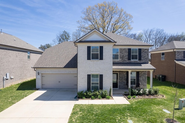 view of front of property featuring a front yard, a garage, brick siding, and concrete driveway