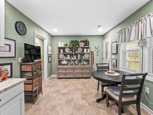 dining space featuring baseboards and visible vents