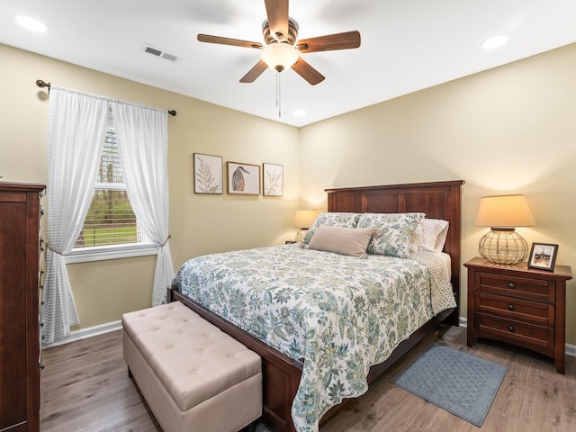 bedroom featuring baseboards, visible vents, recessed lighting, and wood finished floors
