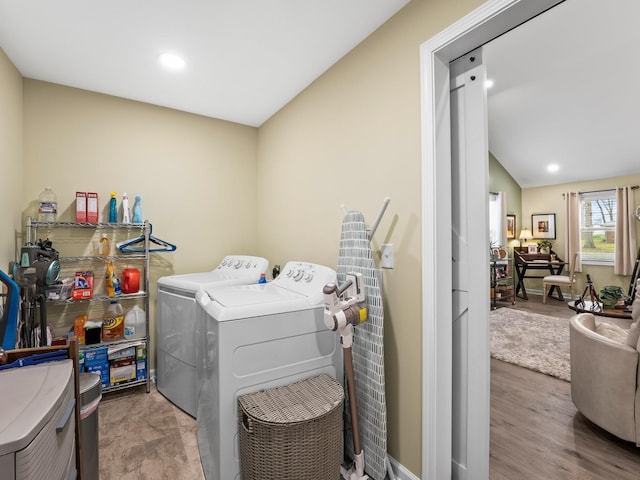 washroom featuring wood finished floors, washing machine and clothes dryer, laundry area, and recessed lighting