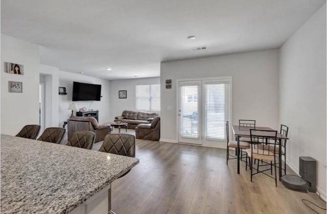 dining area with recessed lighting, visible vents, wood finished floors, and baseboards