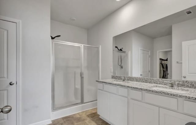 full bath featuring visible vents, a shower stall, and a sink