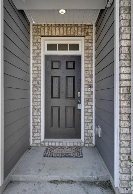 entrance to property with brick siding