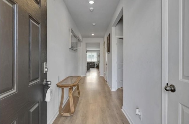 entrance foyer featuring light wood-style floors, recessed lighting, and baseboards