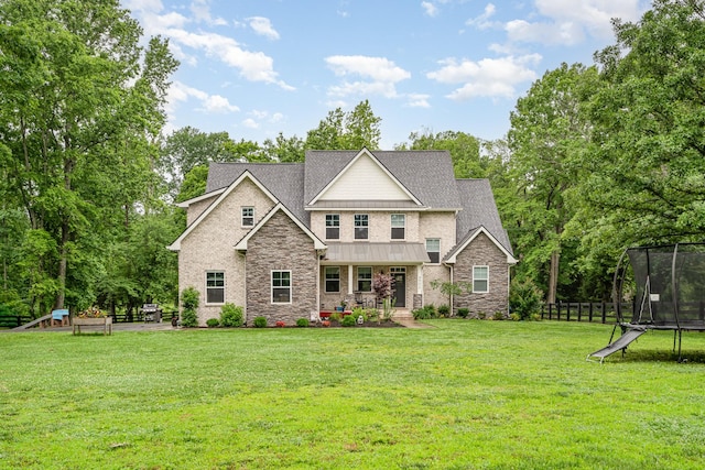 4902 Charles Dorris Rd, Springfield, TN 37172 - craftsman-style home featuring a trampoline, stone siding, a standing seam roof, roof with shingles, and view of scattered trees