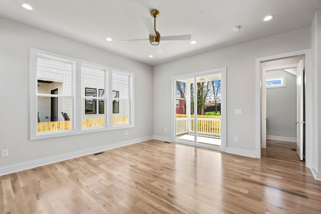 unfurnished room featuring baseboards, ceiling fan, light wood-style flooring, and recessed lighting