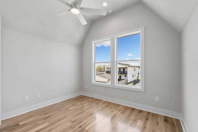 bonus room featuring vaulted ceiling, light wood-style floors, and a ceiling fan