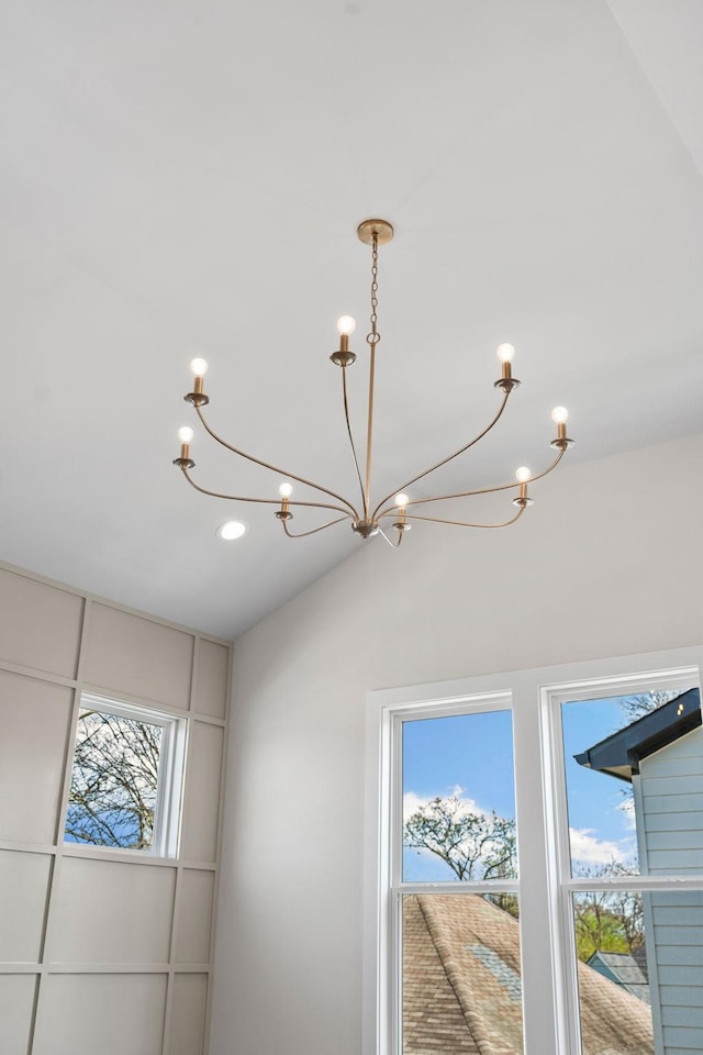details with recessed lighting and an inviting chandelier