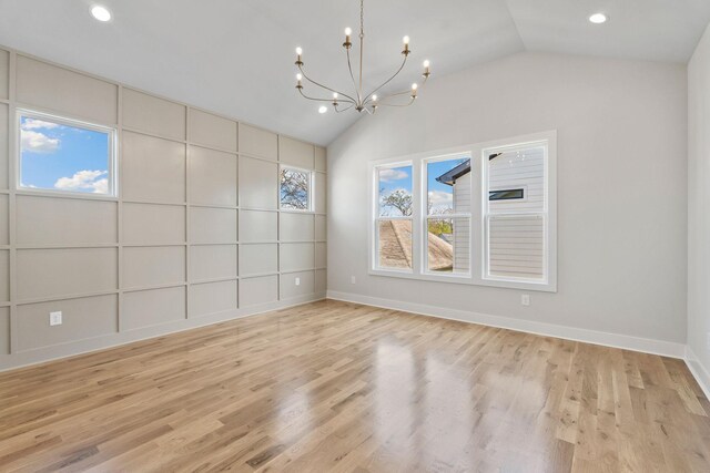 unfurnished room with an inviting chandelier, light wood-style flooring, lofted ceiling, and recessed lighting