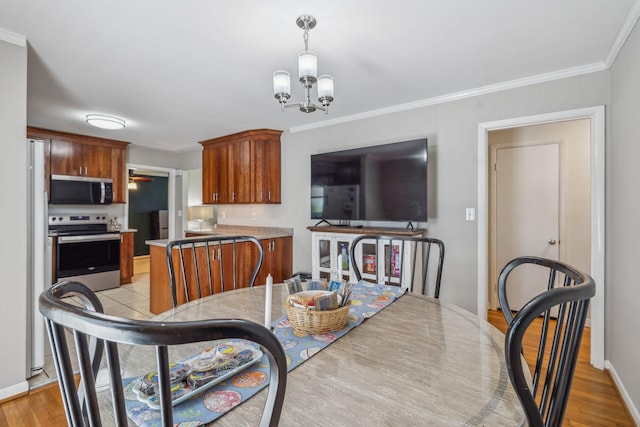 3132 Stafford Dr, Nashville, TN 37214 - dining room with baseboards, crown molding, light wood-style flooring, and a chandelier