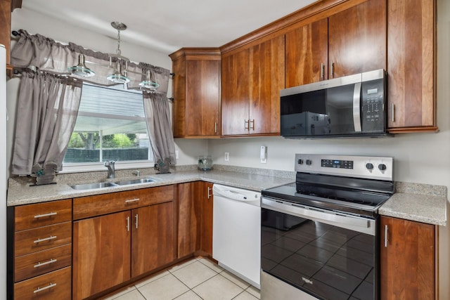 3132 Stafford Dr, Nashville, TN 37214 - kitchen featuring light tile patterned flooring, a sink, stainless steel appliances, and brown cabinets