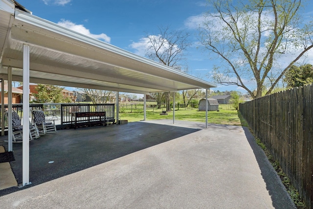 3132 Stafford Dr, Nashville, TN 37214 - view of parking featuring a fenced backyard, a carport, a storage unit, and aphalt driveway