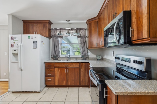 3132 Stafford Dr, Nashville, TN 37214 - kitchen with decorative light fixtures, stainless steel appliances, a sink, light tile patterned flooring, and brown cabinets