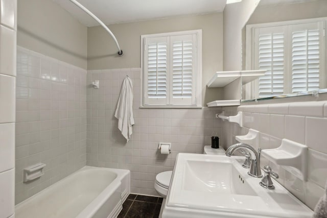 3132 Stafford Dr, Nashville, TN 37214 - full bathroom featuring tile patterned flooring, tile walls, toilet, a sink, and shower / tub combination