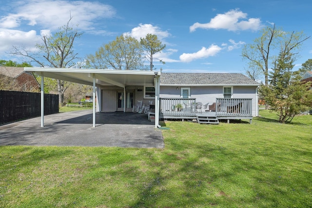 3132 Stafford Dr, Nashville, TN 37214 - rear view of house featuring a lawn, an attached carport, fence, and aphalt driveway